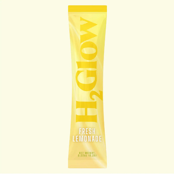 Yellow plastic bottle with bold “FRESH LEMONADE” lettering and stylized starburst graphic, centered on a cream background.