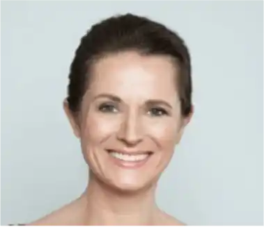 Smiling woman with dark hair pulled back, light skin, and a soft gray background