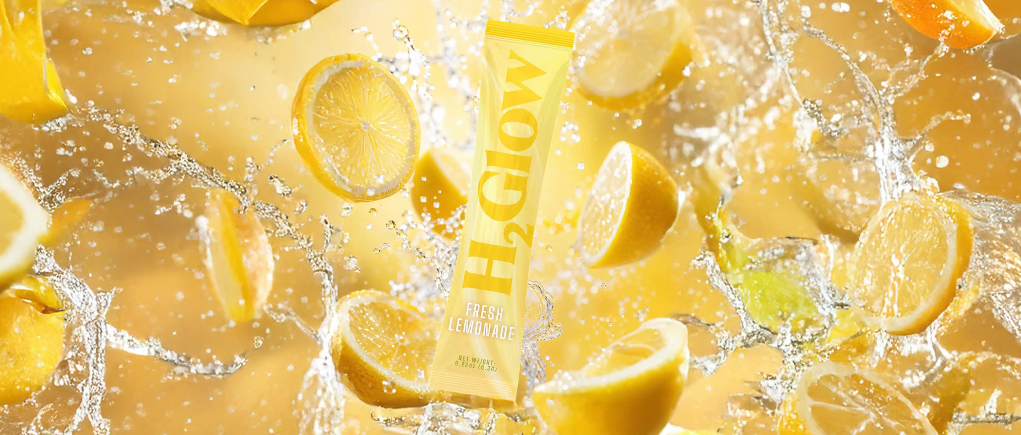 Fresh lemonade drink tube in yellow with bold letters, surrounded by lemon slices and sparkling splash droplets.