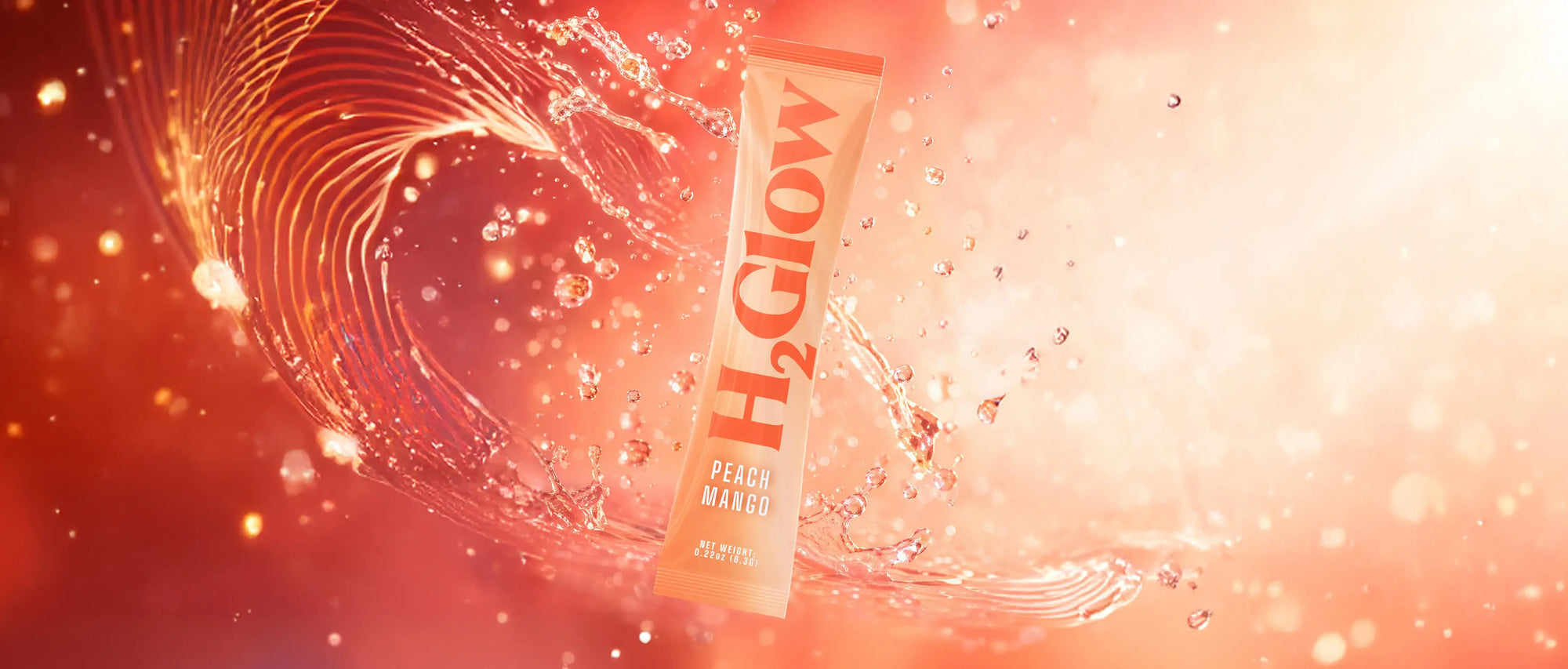 A white drinks pouch labeled PEACH MANGO floats in a red water splash with bubbles and droplets.
