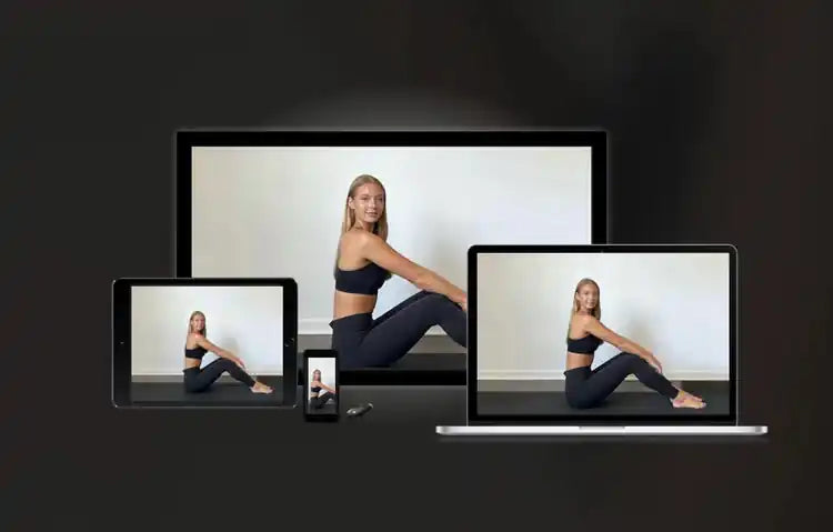 Woman stretching on a dark floor is shown across phone, tablet, and laptop screens in a studio.