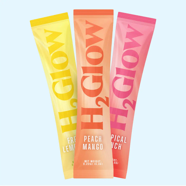 Three bright fruit-flavored snack pouches, yellow peach and pink, with large letters on packaging