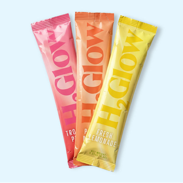 Three bright fruit-flavored snack pouches, fresh lemonade, peach mango and tropical punch on packaging